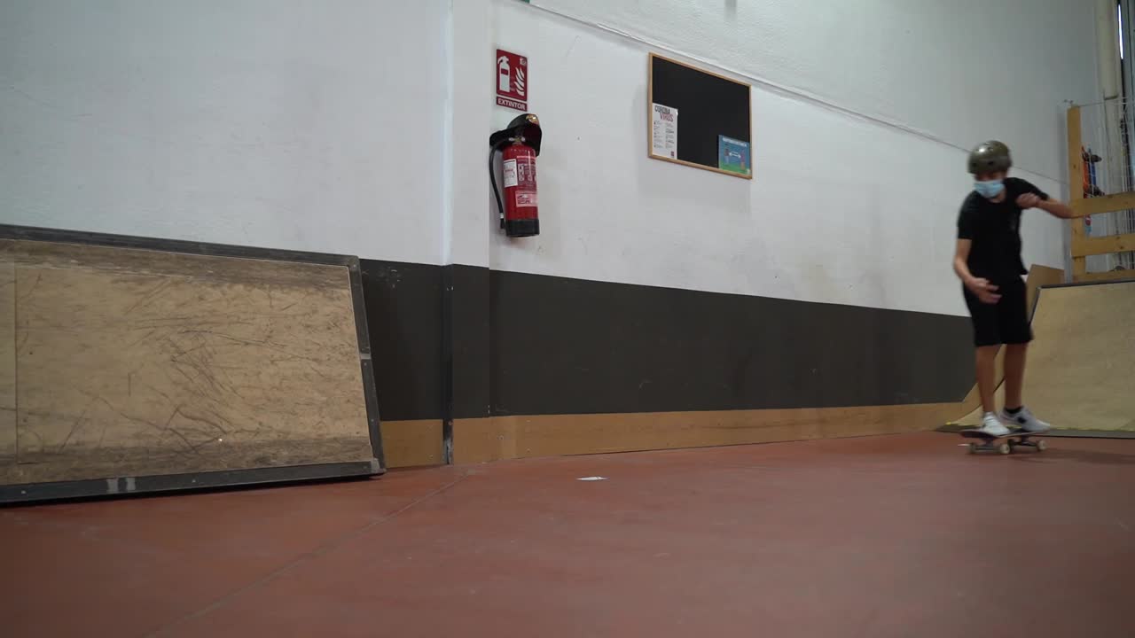 Young people skateboarding in an indoor skatepark