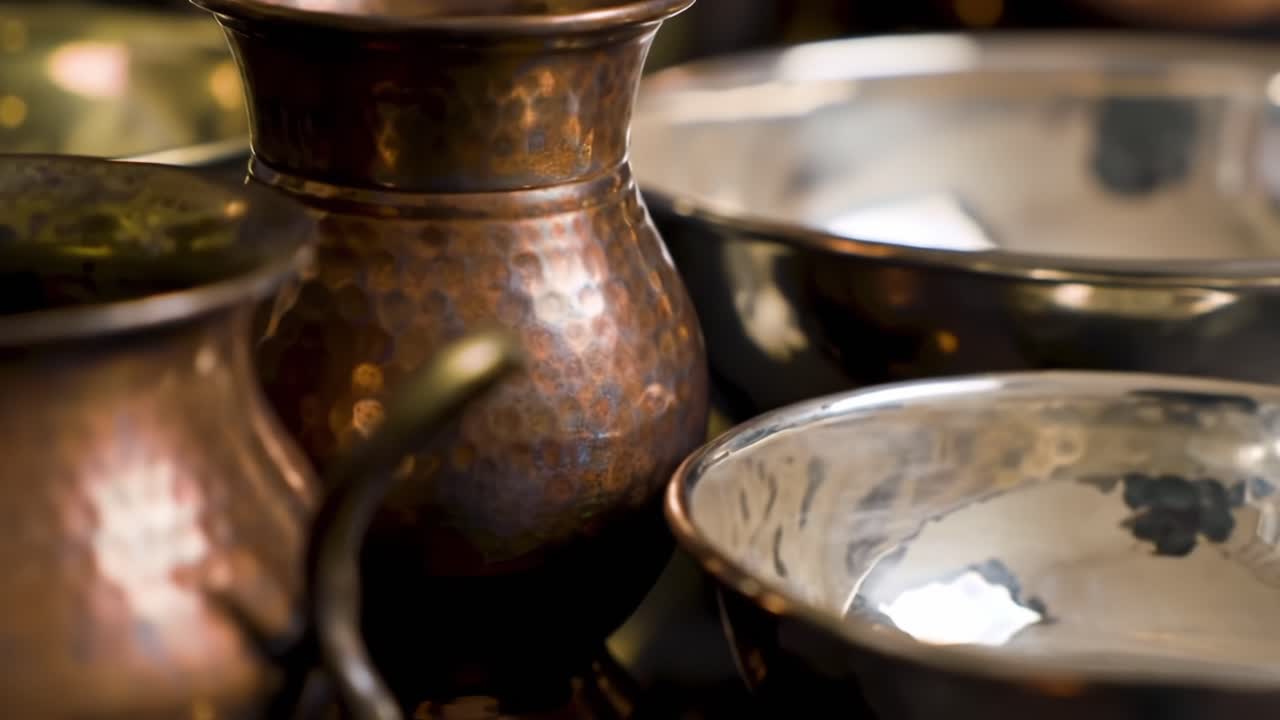 A Captivating Display of Handcrafted Metalware: Stunning Close-Ups of Gleaming Copper and Silver Pots and Bowls Showcasing Artistry and Craftsmanship in Each Detail