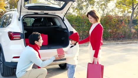 cheerful asian family with father, mother and daughter excited for holiday adventure in compact car are smiling and driving for travel on vacation