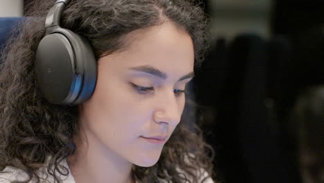 woman wearing headphones working from home