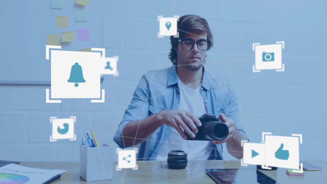 Male creator inspecting DSLR, attaching lenses, tapping tablet, activating social icons for sharing