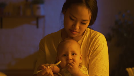 mother feeding baby at night