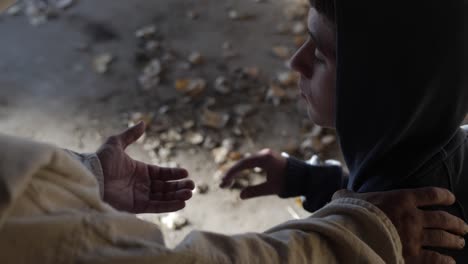 Closeup-of-Jesus-offering-his-hand-to-a-troubled-and-sad-teen-boy