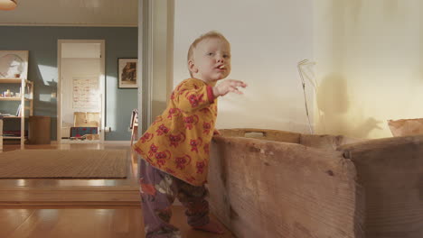 cu - a cute 9 month baby grabs a wood chip from a box and puts it in her mouth