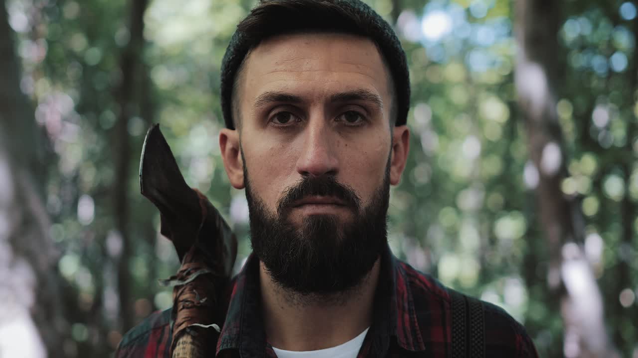 Portrait of a Lumberjack with Axe in Forest