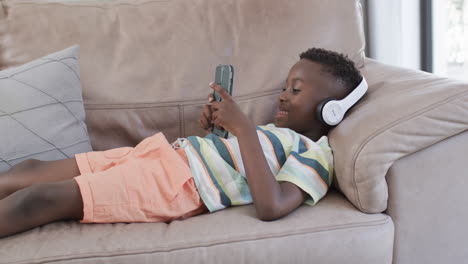 african american boy enjoys music at home