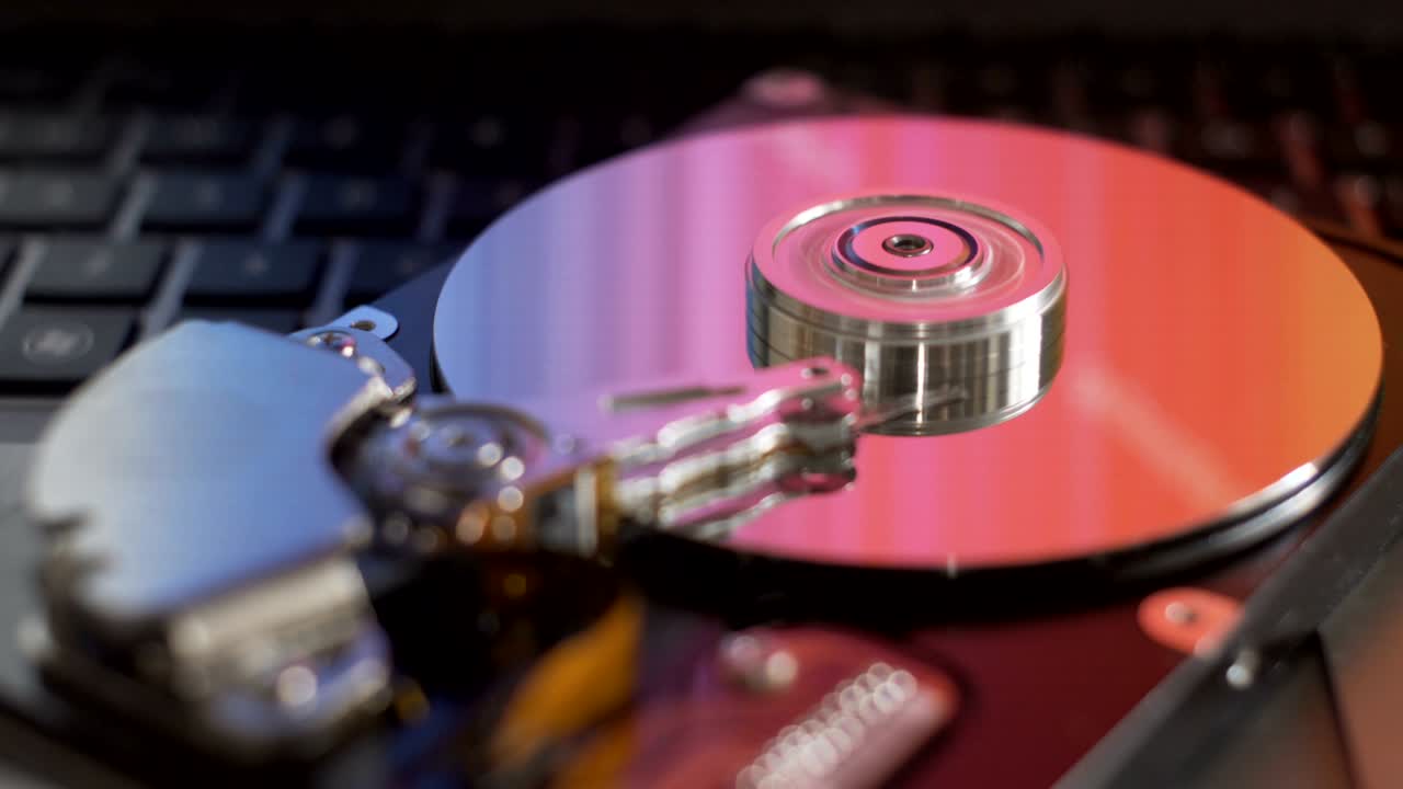 Colorful reflections on disassembled computer hard drive.