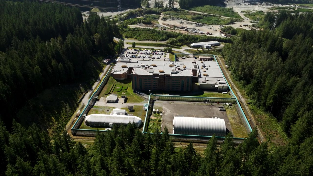 Fraser Regional Correctional Centre, Maple Ridge, British Columbia, Canada - A Daytime Scene of a Correctional Facility Surrounded by a Dense Forest - Aerial Drone Shot