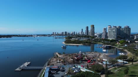 construction of a new adventure park created on the foreshore with a city skyline backdrop high drone view