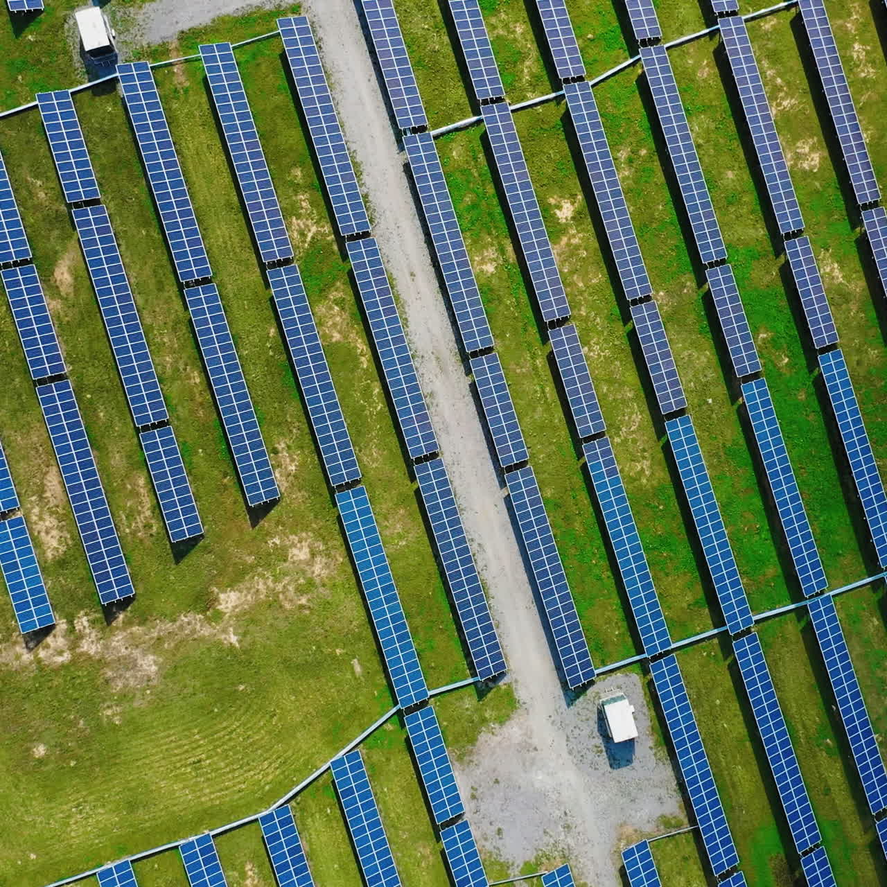 Top view on the field with many solar panels. Alternative clean electricity. Aerial view. Camera is moving around.