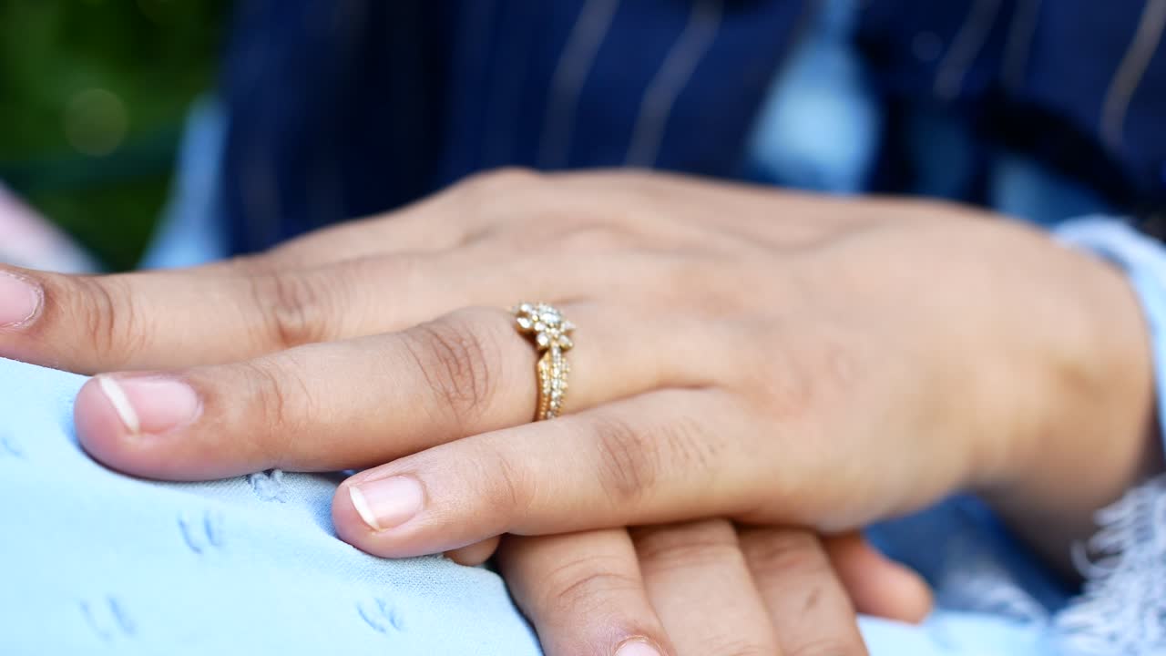 Close up of womens hands with wedding ring ,