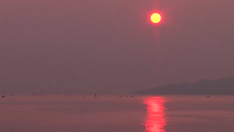 sun setting in smokey sky