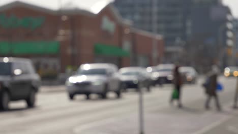 pedestrians walking crossing the street in front of slow cars