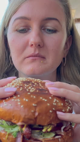 a hungry woman eats a big burger street food junk food hot dog burger hamburger a hungry woman eats a big burger street food junk food hot dog burger hamburger