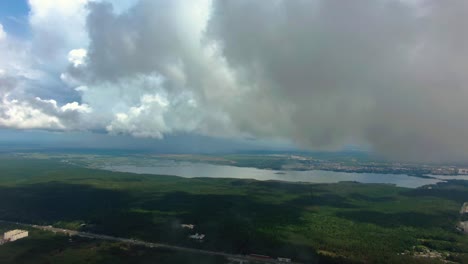 aerial view of a stormy landscape with a lake and city