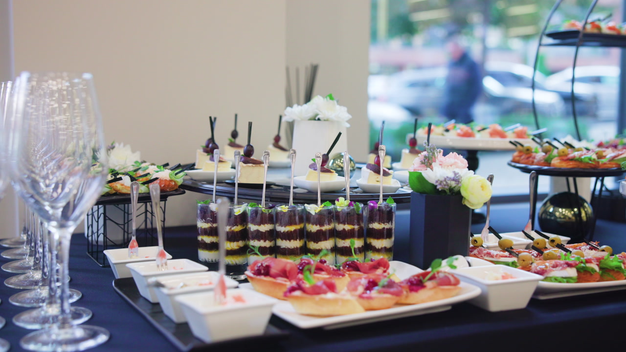 Elegant Catered Appetizer Buffet Table With Layered Canapes, Charcuterie Cups, Colorful Garnishes, Glass. Creative