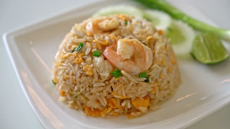 fried rice with shrimps and crab on white plate