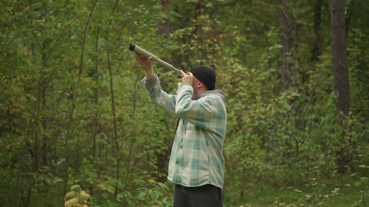 caucasian man forest blowing wooden horn calling birds along mossy trail, plaid shirt with binoculars strap, hiker practicing survival signal, field ornithologist mimic, ranger training tone, soft