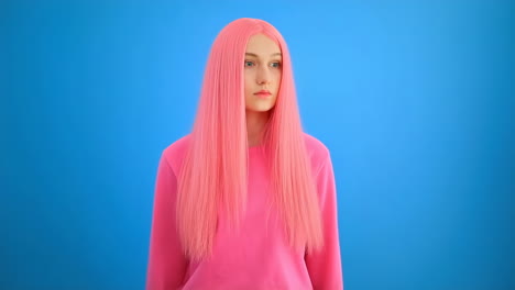young woman with long pink hair on a blue background