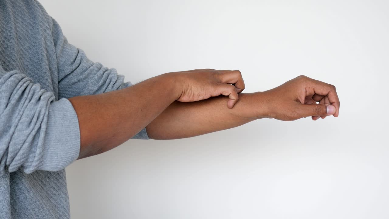 Man scratching his wrist