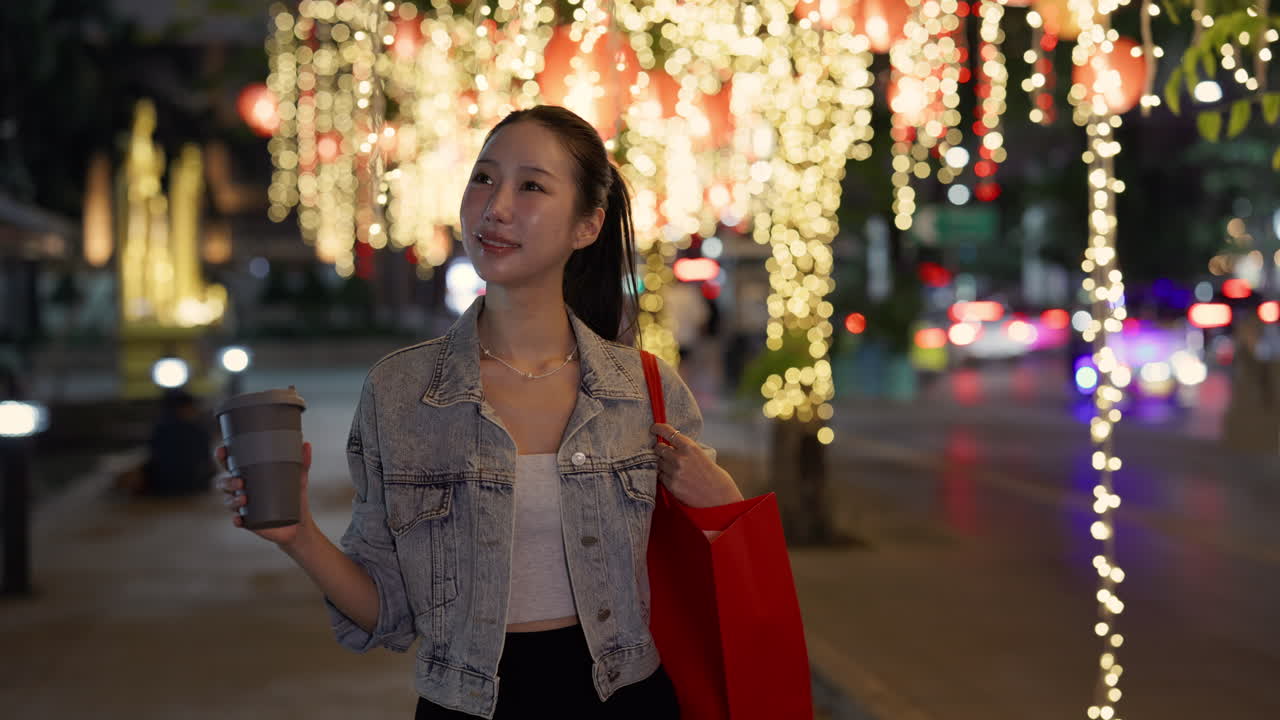 Asian woman on city street at night