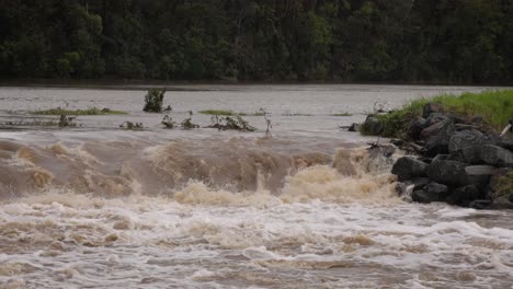 Coomera,-Gold-Coast,-2-January-2024---Close-shot-of-Coomera-River-Causeway-under-flood-waters-from-the-2024-Storms-in-January