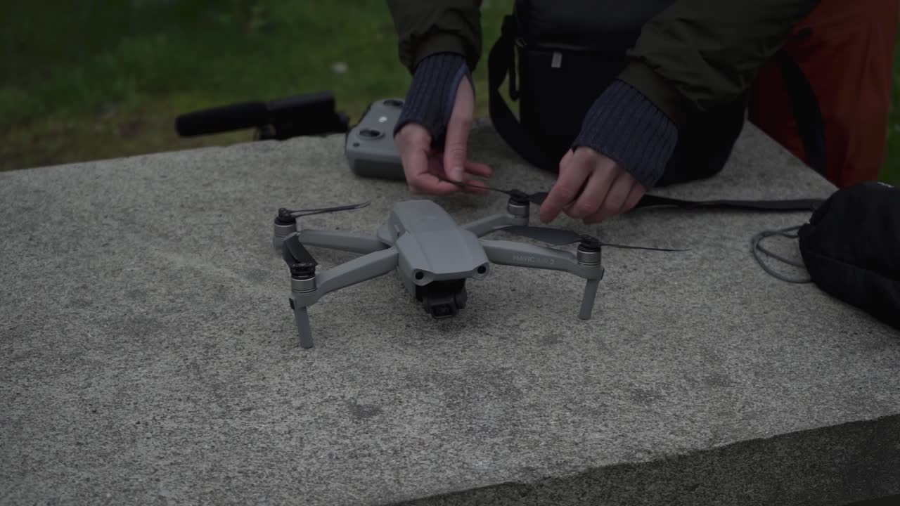 Person unfolding DJI drone and preparing to fly, close up view
