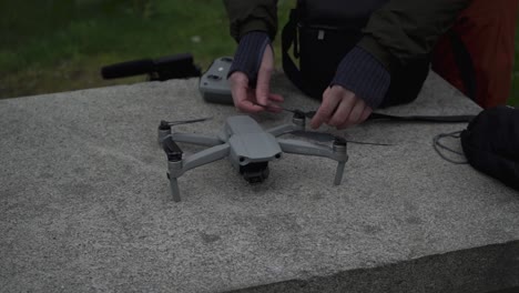 person unfolding dji drone and preparing to fly, close up view