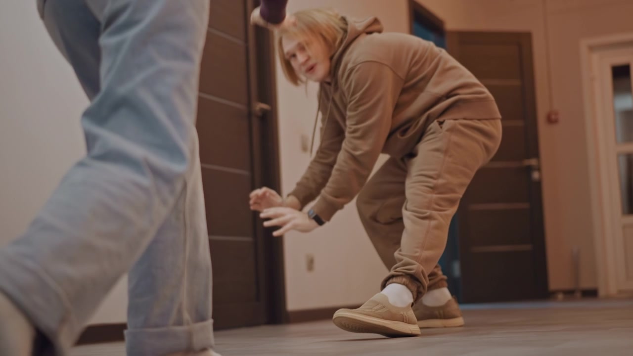 Closeup feet practice white and asian students rehearse steps and timing, slippers and sneakers on wooden floor, dance warmup led by coach, casual jeans, partner drills, lively rhythm