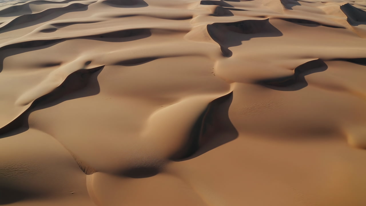 Aerial Desert Sand Dunes Undulating Golden Drone Cinematic Footage Showcasing Smooth Rippling Ridges, Deep