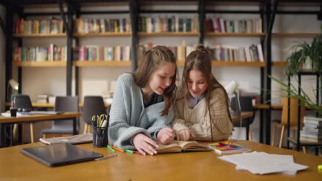 teenage girls studying in a library