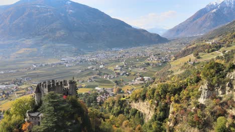 Aerial-Drone-Over-a-medieval-Castle-in-the-middle-of-the-Vineyards-in-Italy