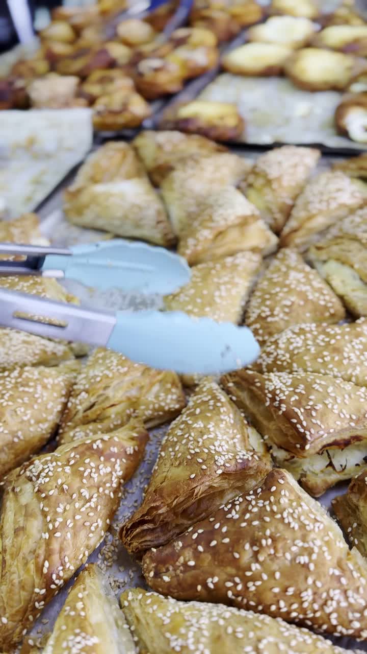 Assortment of triangular pastries with sesame seeds