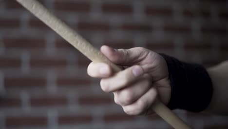 person working out with a stick