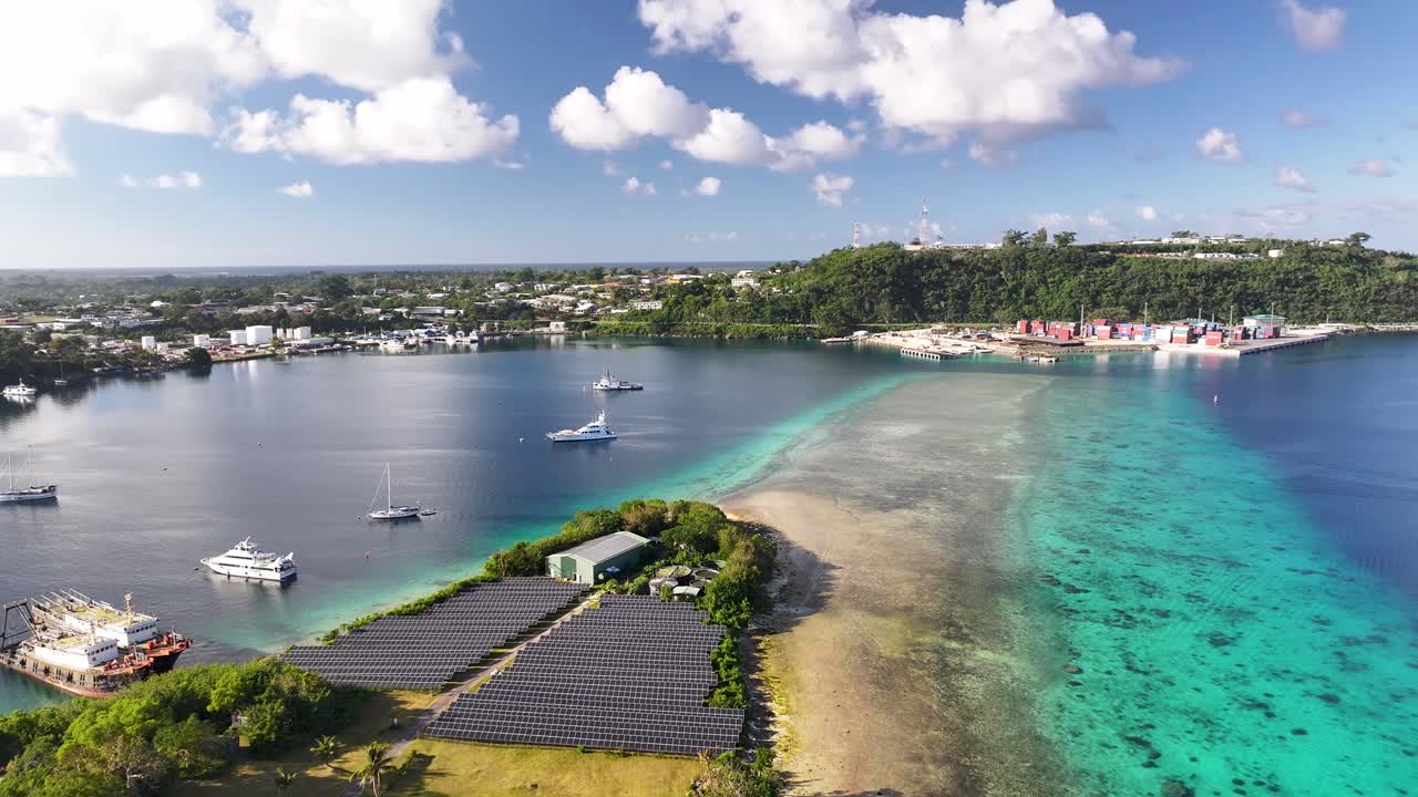 Aerial View of Tropical Island with Solar Panels and Coral Reef