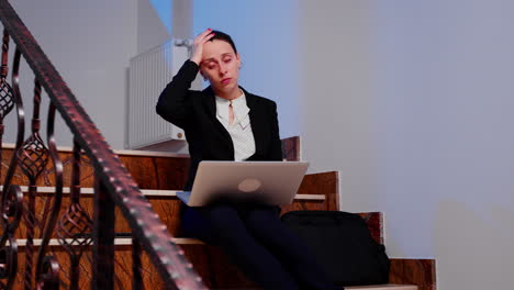 businesswoman with headache working on laptop