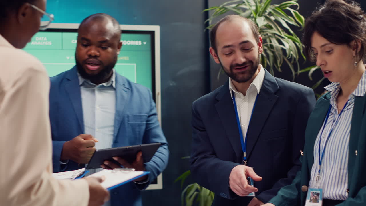 Supervisor and employees attend a status update meeting