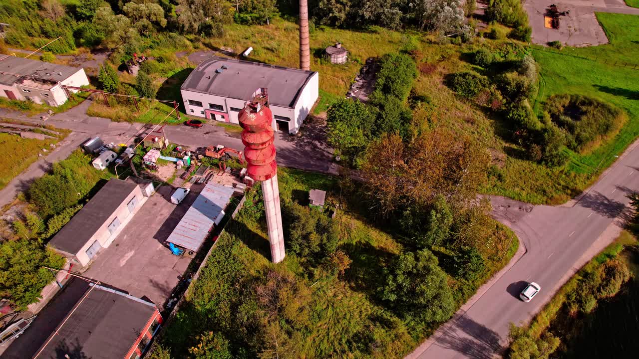 Aerial view of an industrial area in Latvia surrounded by greenery