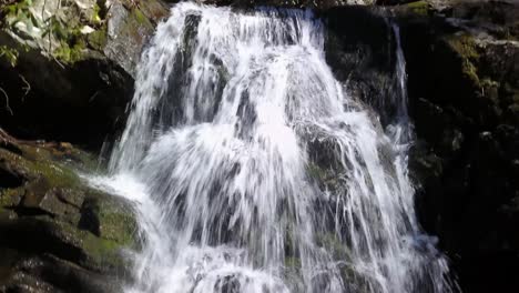 aerial pan down of waterfall in appalachian mountains