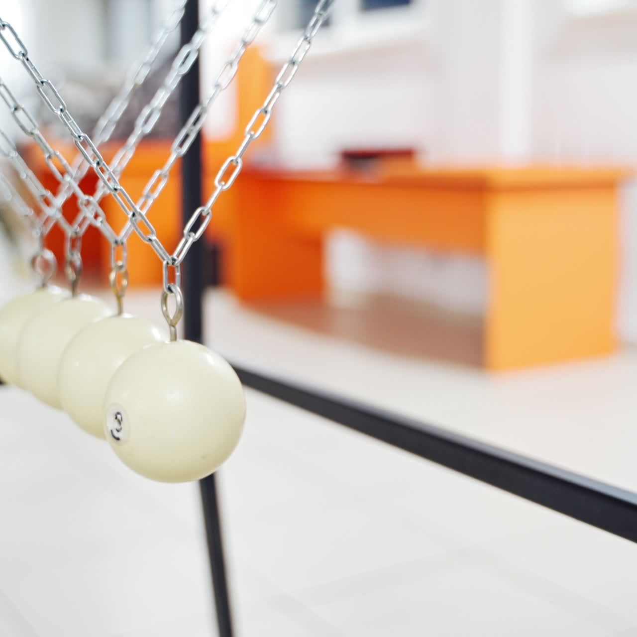 Newton's cradle showing laws of physics in motion. Museum of Science