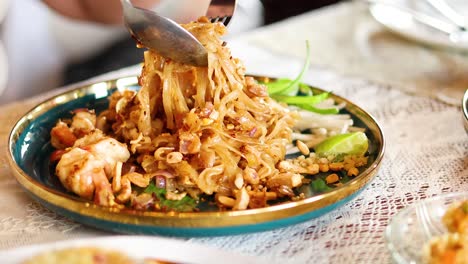 savoring delicious pad thai with shrimp