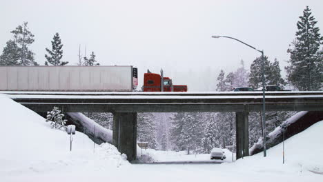 snow falls during a traffic jam on an overpass in the afternoon