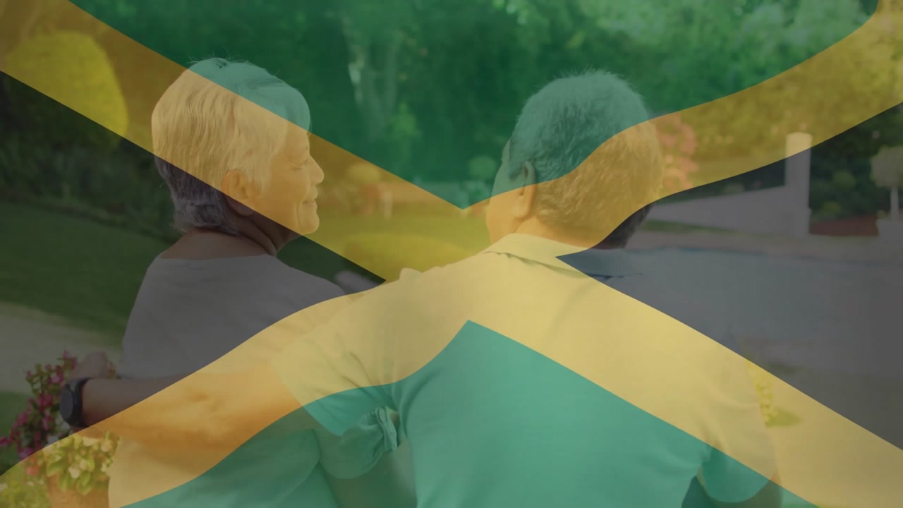 Senior couple sitting on bench in garden, showing wristwatch and health theme flag overlay