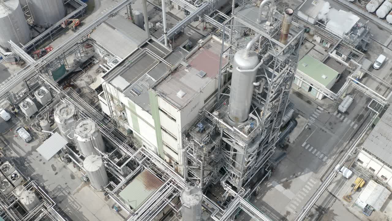 Aerial descending view of DRT complex industrial processing unit with numerous pipes, towers, and tanks, Veille-Saint-Girons, France