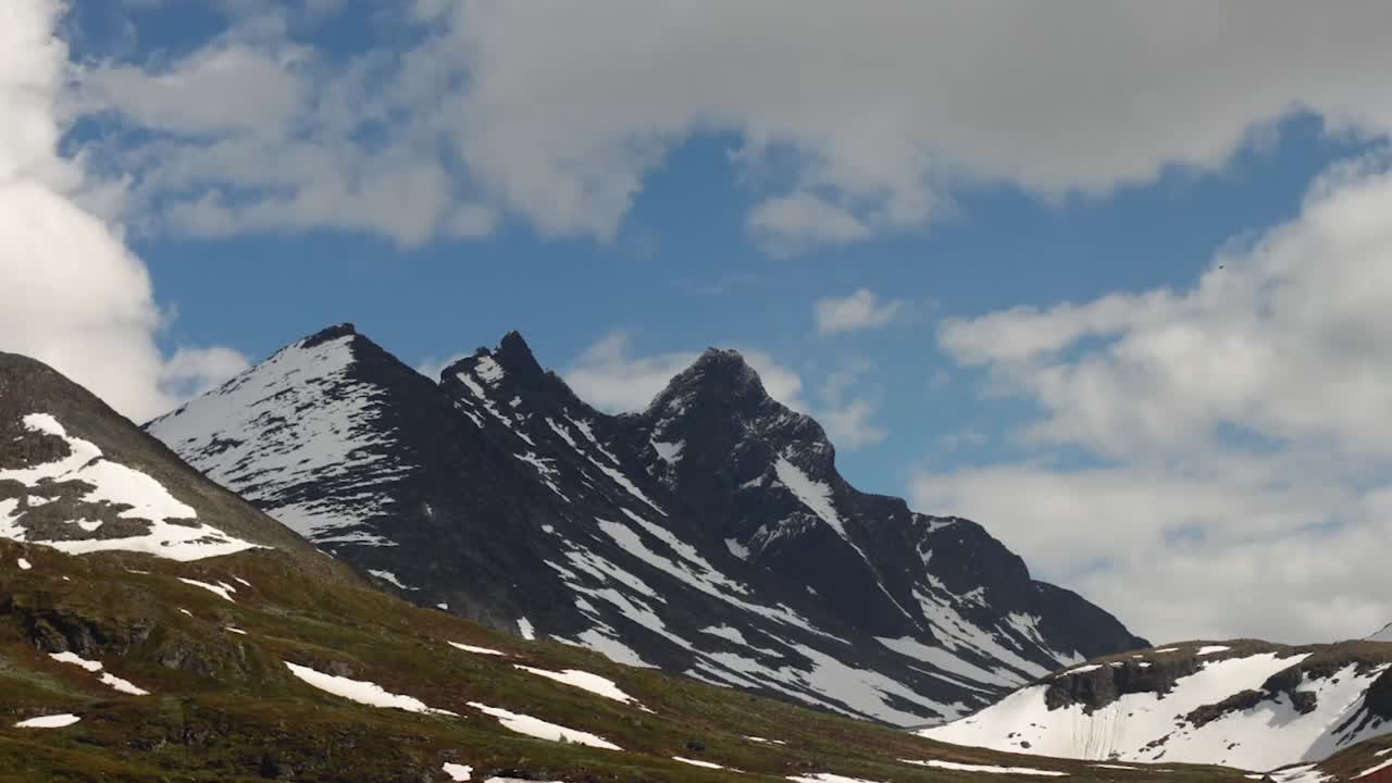 Time-lapse of Skagastølstindane in Jotunheimen, Norway with light clouds passing over.