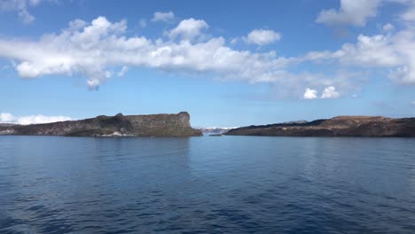 Sailing-by-Nea-Kameni-Island-in-Santorini-Caldera-in-Mediterranean-Sea