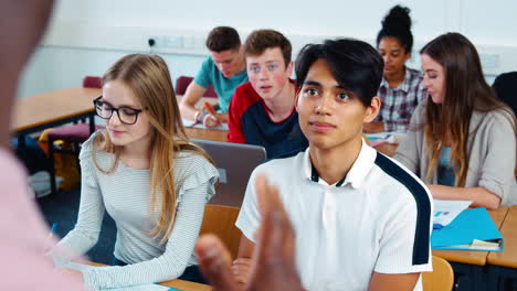 college students in class viewed from behind teacher