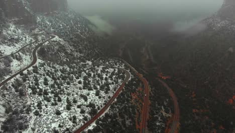 aerial view of a winding mountain road in the snow