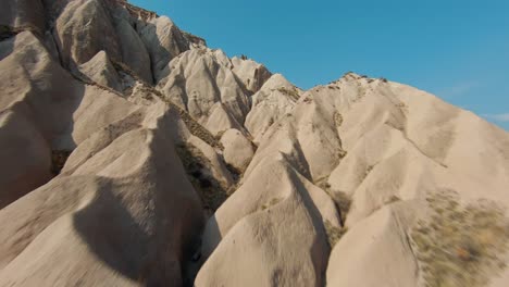 FPV---Flying-To-The-Fairy-Chimneys,-Unique-Rock-Formation-In-Cappadocia,-Turkey