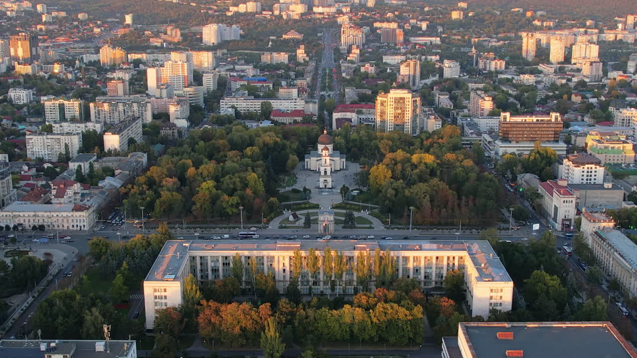 Aerial drone view of Chisinau downtown at sunset, Moldova. View of Central Park, Cathedral, Goverment and a lot of greenery, buildings